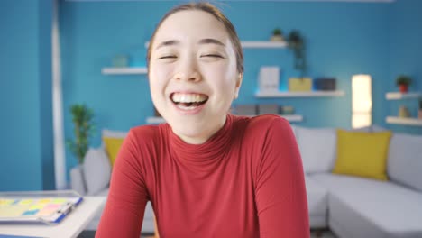 Happy-Asian-woman-laughing-at-camera.